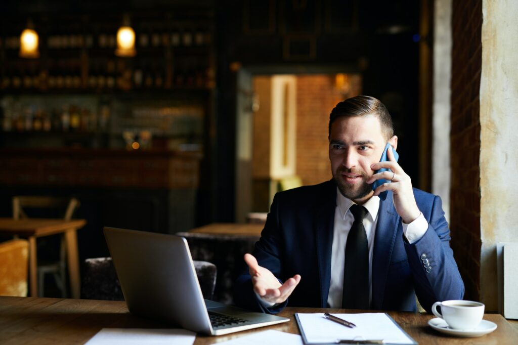 Businessman solving work issues on phone