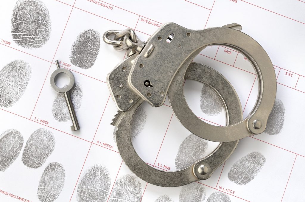 handcuffs-on-fingerprint-sheet